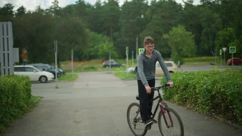 Young Boy Riding Bicycle on Interlock Path in Quiet Suburban Setting Surrounded Stock Footage 287852457