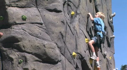 Young Boy on Rock Climbing Wall Stock Footage