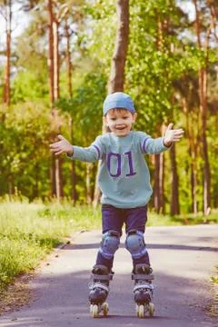 Young boy rollerskating at the park Stock Photos
