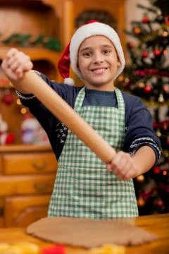 Young boy with rolling pin preparing Christmas cookies Stock Photos