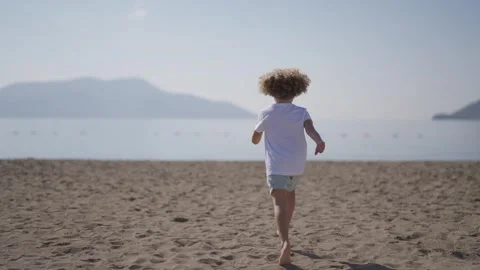 Young Boy Running on Beach Stock Footage 302332149