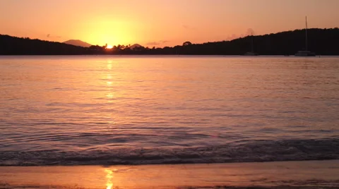 Young boy running with coconut at sunset on a tropical beach  Stock Footage 67666029