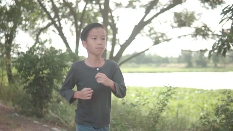 Young boy running during summer day Stock Footage 113535802