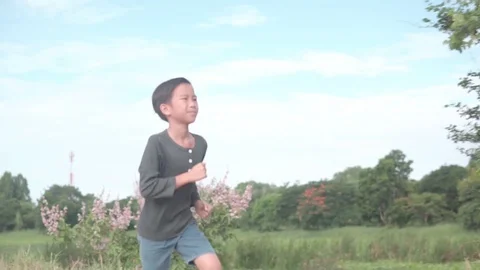 Young boy running during summer day Stock Footage 113535803