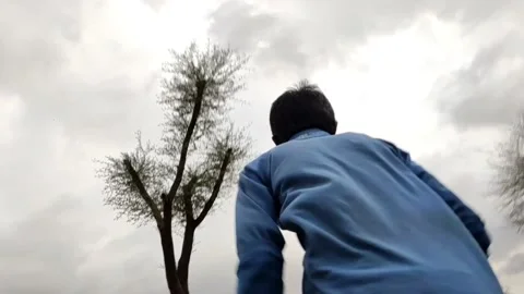 A young boy running in forest, slow motion footage, backside low angel view Stock Footage 157703762