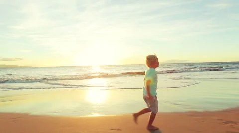 Young Boy Running for Fun into his Fathers Arms at the Beach at Sunset. Video stock 56531490