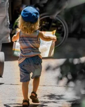 Young boy running with a map Stock Photos