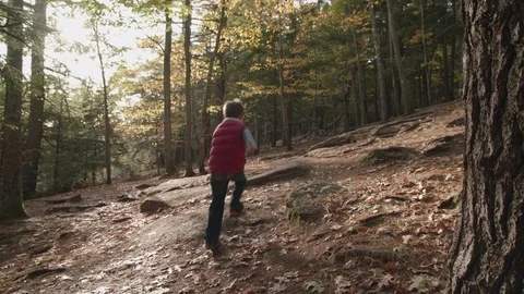 Young boy running up mountain trail Stock Footage 81526258