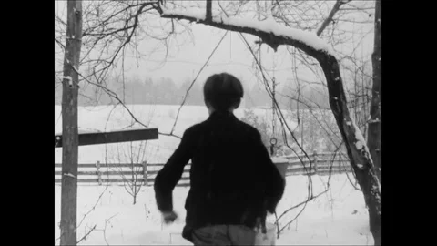 Young Boy Running To School Through Snow Covered Landscape Stock Footage 113298612