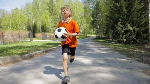 Young boy running with soccer ball Stock Footage 50142346