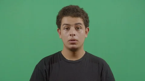 Young boy saying woo at the viewer from a calm state to an unpredictable posture Stock Footage 115337877