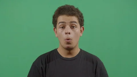 Young boy saying wow at the viewer from a calm state to an unpredictable posture Stock Footage 115337862