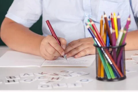 Young boy at school writing assignment Stock Photos