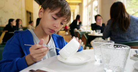 Young boy scraping empty soup bowl with spoon to get very last drops Video stock 322099263