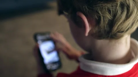 A young boy scrolling through social media on a smartphone Vídeo Stock 294340870