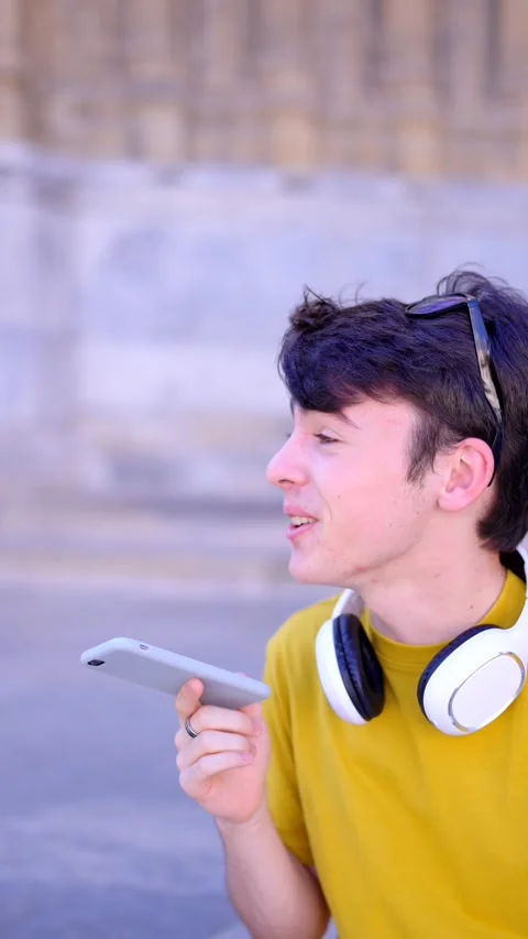 Young boy sending voice message on phone Stock Footage 252641088