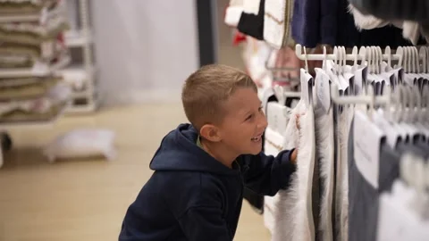 Young Boy Shopping for Clothes in a Retail Store 스톡 동영상 333618136