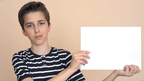 Young boy showing blank white paper Stock Footage 88320610