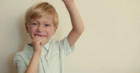 A young boy shows a chocolate candy to the camera with one hand, and with the Video stock 346982829