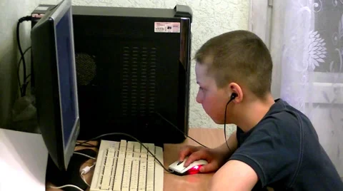 Young boy sits at computer and yawns Stock Footage 63228290