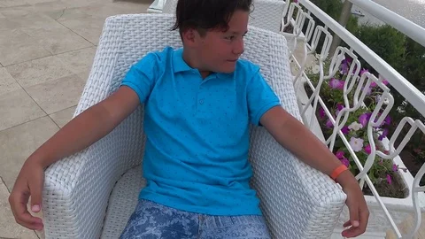 Young boy sitting at the outdoors Stock Footage 77004667