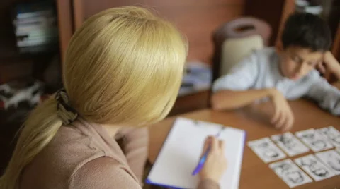 Young boy sitting in silence during session with young psychologist. Stock Footage 67994917