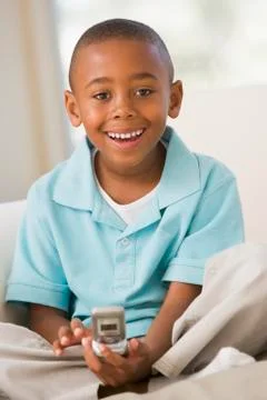Young Boy Sitting On A Sofa, Text Messaging Stock Photos