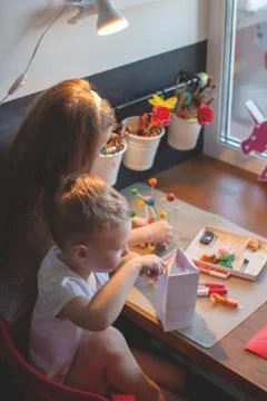 A young boy sitting at a table Stock Photos