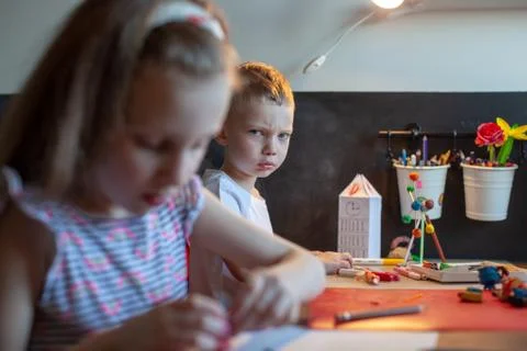 A young boy sitting at a table Stock Photos