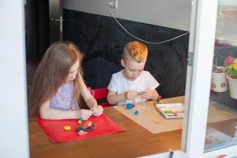 A young boy sitting at a table Stock Photos