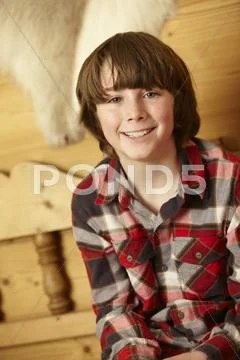 Young Boy Sitting On Wooden Seat Stock Photos
