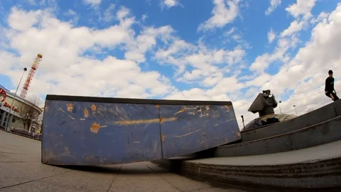 A young boy on a skateboard doing trick on the brink Stock Footage 71819902