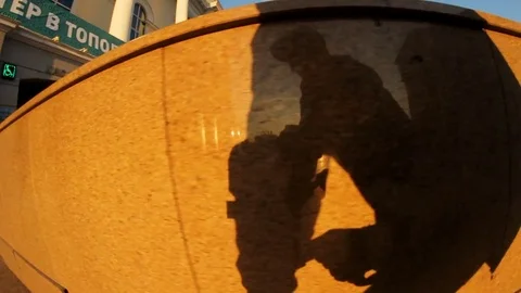 A young boy on a skateboard doing tricks in the city center Stock Footage 71819528