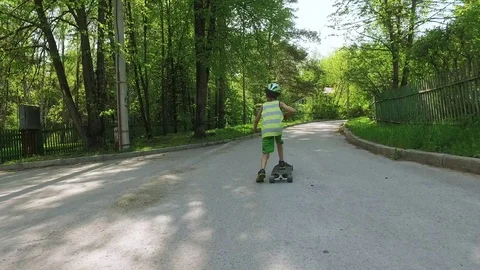 Young boy skating long board in summer day. Stock Footage 77538587