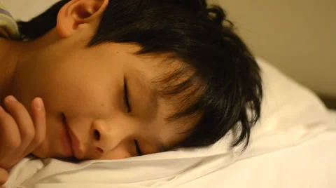 Young boy sleeping at night Stock Footage 51553108