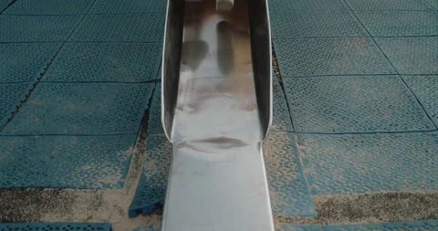 Young boy sliding to the bottom of a sli... | Stock Video | Pond5