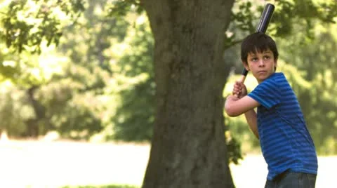Young boy in slow motion playing baseball Stock Footage 10815899