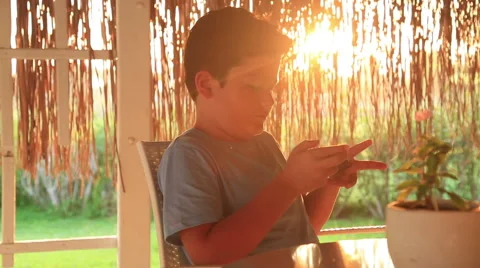 Young boy with smartphone in summer cafe 4 Stock Footage 66508970