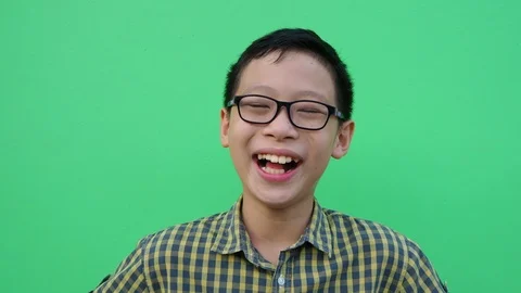 Young boy smiling  in front of green screen Stock Footage 88934661