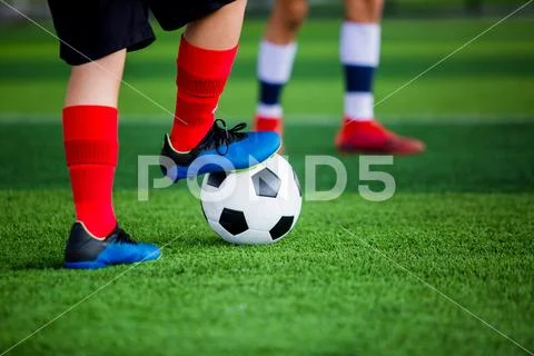 Young boy soccer players run to trap and control the ball for shoot to goal Stock Photos
