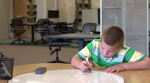 Young boy solving math problem looks up and smiles Stock Footage 26586063