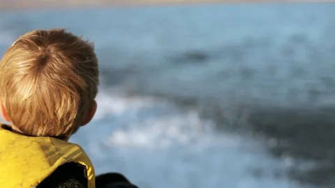 A young boy on a speedboat. Stockbeeldmateriaal 88367488