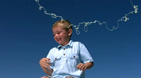 Young boy is sprayed with silly string, slow motion Stock-Footage 61670322