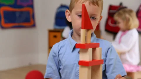 Young boy stacking blocks Stock Footage 32710832