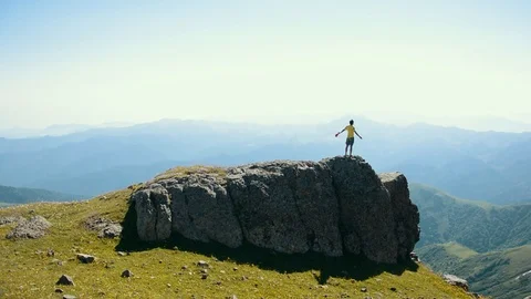The young boy is standing and feeling freedom at the nature.  Stock Footage 121855619
