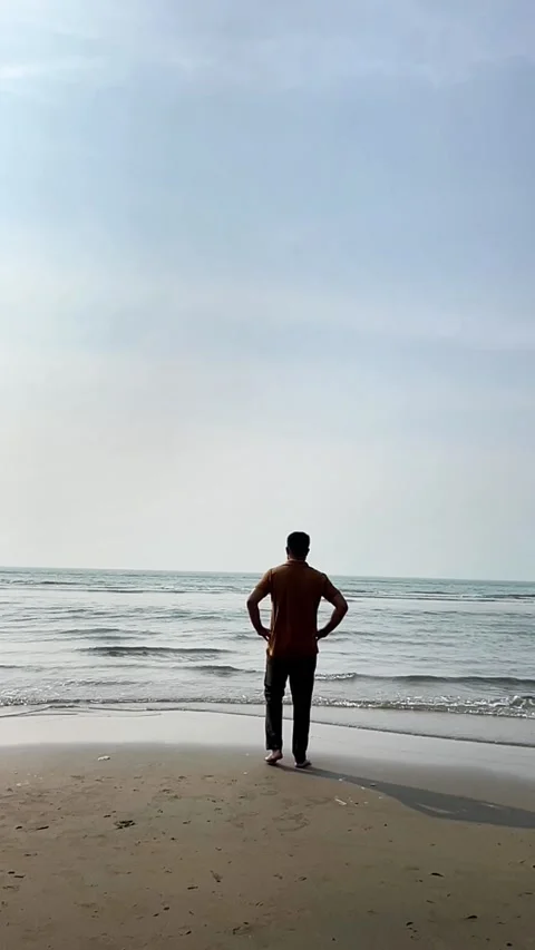 Young Boy Standing on Beach with Arms Wide Open as Waves Touch Stock-Footage 311697307