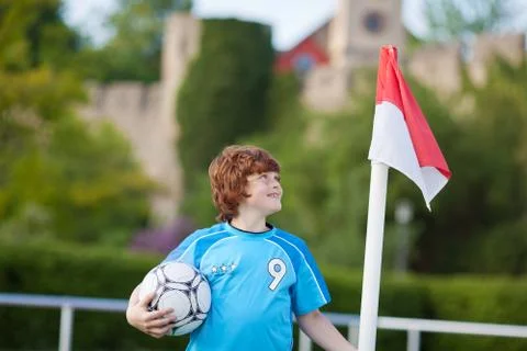 Young boy standing at corner flag Stock Photos