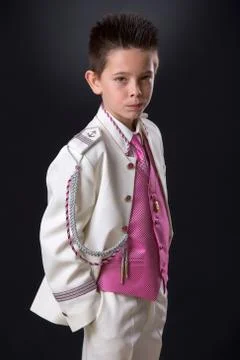 Young boy standing looking seriously in his First Holy Communion Stock Photos