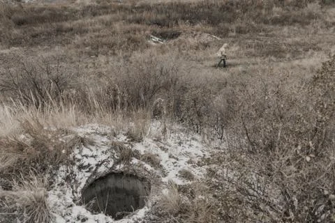 Young boy stands near an abandoned bunker Stock Photos