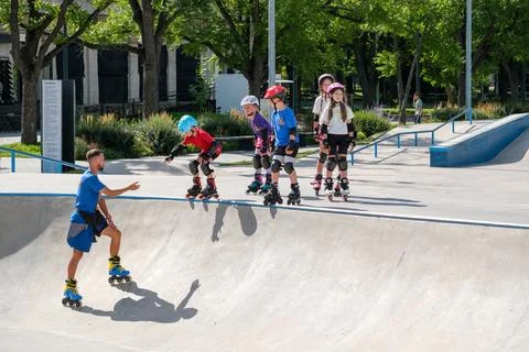 Young Boy Starting Inline Skating Lesson at Skatepark Bowl Stock Photos